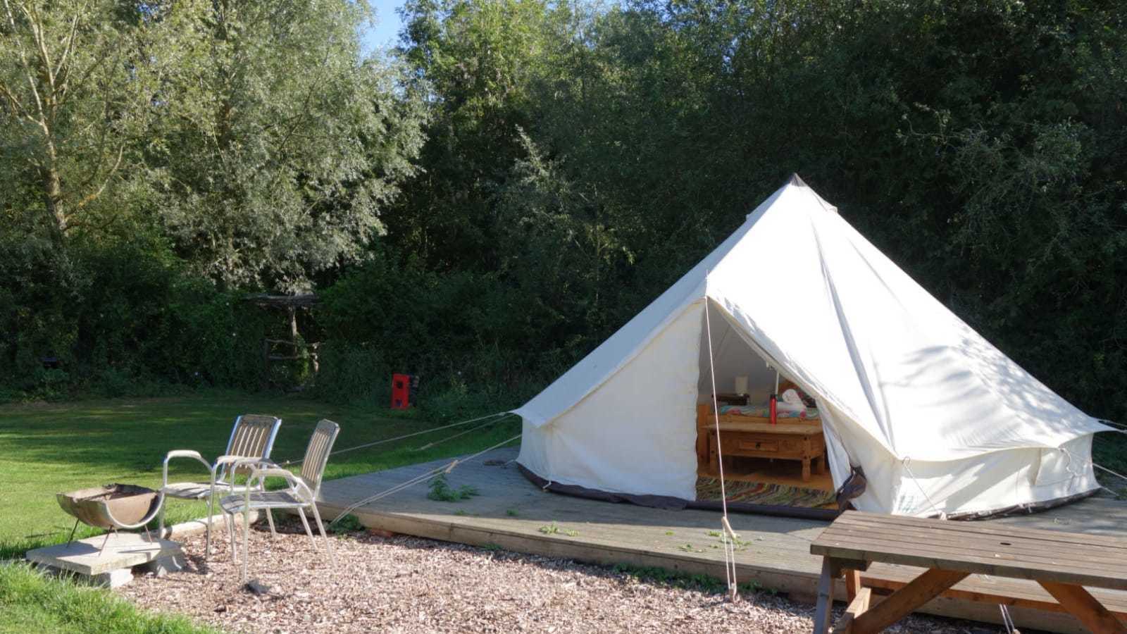 Glamping tent outdoors in field 